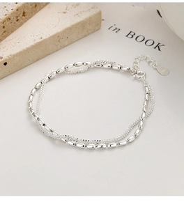 Macro detail of S925 sterling silver double-layer bracelet with hallmarks and rice beads