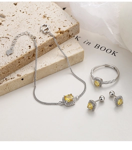 Macro view of 925 sterling silver jewelry set with yellow halo square zircon stones