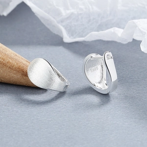 Minimalist 925 sterling silver hoop earrings with brushed matte finish on dark background