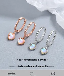 Macro shot of 925 sterling silver heart moonstone earrings in rose gold and silver