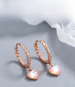 Macro detail of 925 silver heart earring with moonstone pendant and rope texture