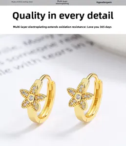 Detail of 925 sterling silver gold flower hoop earrings with sparkling crystal stones