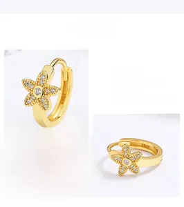 Detail of sterling silver star-shaped hoop earrings with exquisite polishing and white zircon
