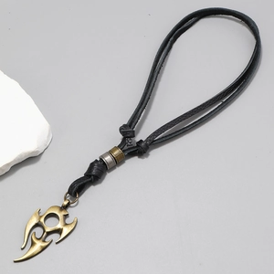 Detail of adjustable black leather necklace with tribal bronze flame pendant and metal beads