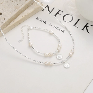925 silver bracelet and necklace set with white pearls and heart charm on Kinfolk magazine