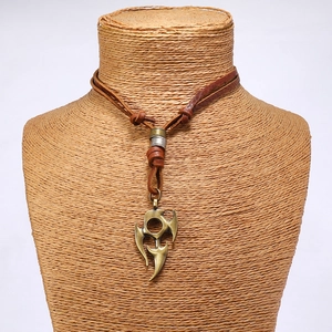 Detailed view of adjustable brown leather cord necklace with bronze tribal totem pendant