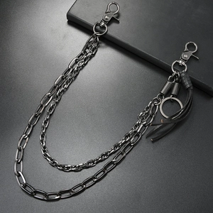 Double-layer gunmetal punk chain for jeans with tassels and snap hooks on dark background