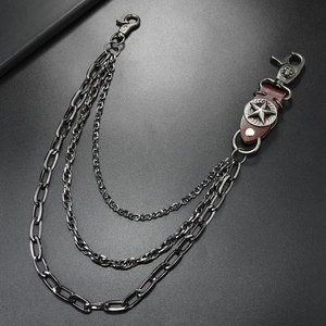 Detailed view of triple-layered metal pants chain with star leather patch and lobster clasps