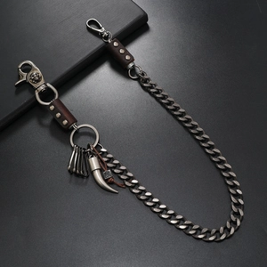 Detail of punk hip-hop waist chain with skull relief and bull horn charm pendants