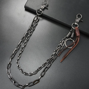 Detail of gunmetal multi-layered trouser chain with vintage leather tassel and clasps