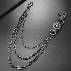 Detailed close-up of triple-layered gunmetal punk chain with star and skull charms