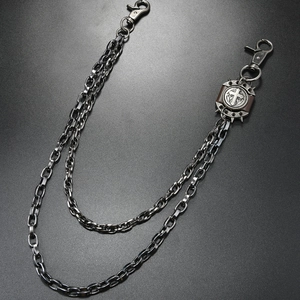 Detail of dual-layer gunmetal biker chain with lobster clasps and cross pendant decoration