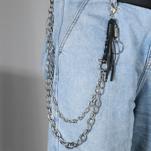 Detail of multi-layer hip hop metal trousers chain with black woven leather and tassels
