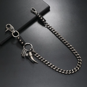 Macro detail of punk metal wallet chain with skull clasp and heavy curb links