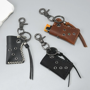 Detailed macro view of vintage leather lighter cases with metal rivets and sturdy keychains