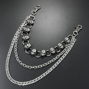 Macro shot of punk style multi-layer metal wallet chain with skull studs on black leather