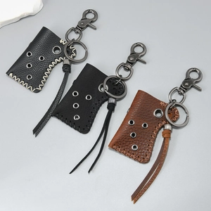 Retro leather keychain pendants in black and brown with metal rivets and tassels