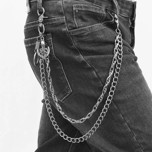Double-layered punk skull hip-hop wallet chain with metallic charms on black jeans