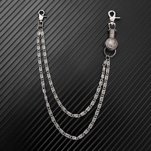 Detail of a double-layered punk metal pants chain with a retro eagle emblem on black metal