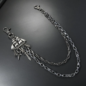 Close-up of retro layered silver pant chain with star and dagger charms for punk style