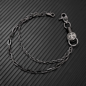 Detail of punk multi-layer metal pants chain with skull lobster clasp and cross charms