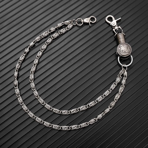 Punk style layered silver wallet chain with eagle coin pendant on black background