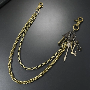 Detail of punk style multi-layer metal belt chain with axe and arrow pendants