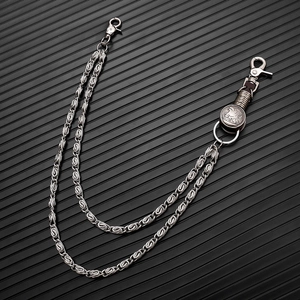 Detail of silver double-layered pants chain with eagle pendant and spiral texture