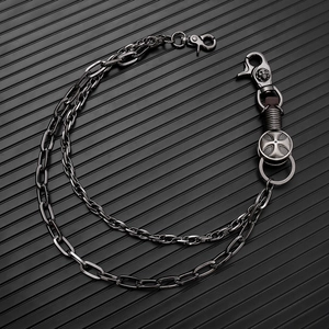 Detail of punk double-layer metal trousers chain with cross charm and skull clasp