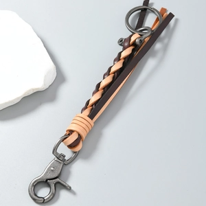 Detailed macro view of retro hand-woven leather keychain with vintage silver hook