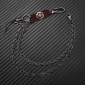 Detail of hip-hop pants chain with double-layered metal links and star leather badge