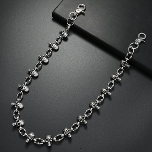 Gothic punk metal skull trouser chain with lobster clasps on dark textured background