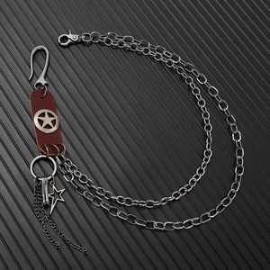 Detail of double-layer punk metal waist chain with leather star accent and lobster clasp