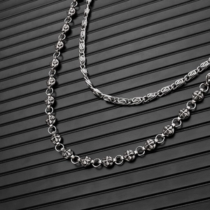 Detailed macro view of vintage double-layer punk metal chains with gothic star links