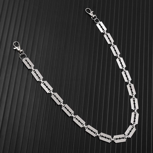 Close-up of punk style silver metal trousers chain with industrial blade shaped links