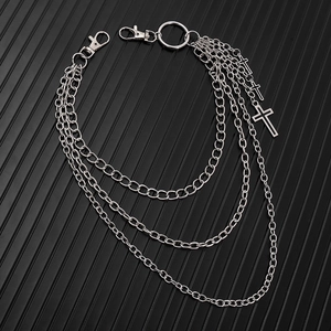 Detailed view of triple-layered silver metal hip hop chains with cross pendants