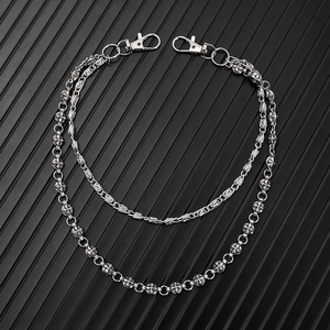 Detail of double-layer punk metal waist chain featuring cross patterns and lobster clasps