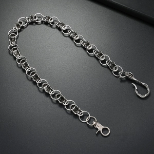 Retro punk style skull pants chain with silver finish and lobster clasps on dark grey base