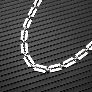 Macro shot of punk style stainless steel silver chain featuring industrial razor blade links