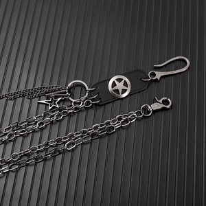 Detail of double-layer punk waist chains with metallic stars and leather patches