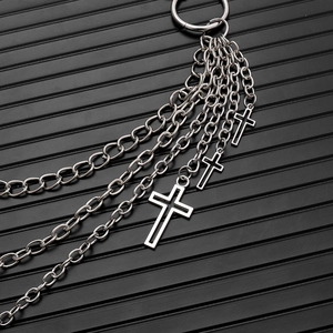 Detail of silver double-layer punk waist chain with three metal cross pendants