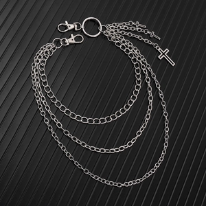 Detail of multi-layer silver pants chain with triple cross pendants and lobster clasps