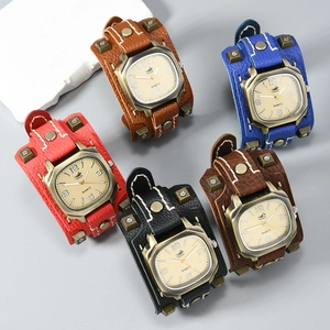 Punk style wide leather cuff watches with vintage studs and visible white stitching