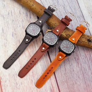 Detail view of retro square quartz watches with distressed leather straps and rivet decor