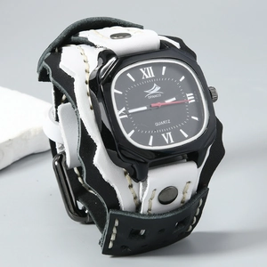 Detail of hand-stitched leather strap and punk-style metal rivets on wide quartz watch