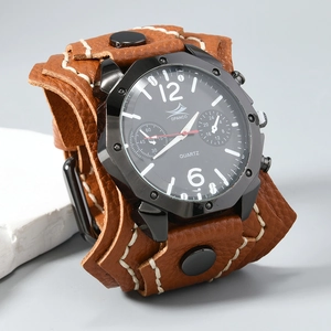 Macro view of brown leather cuff watch band with white stitching and metal snaps