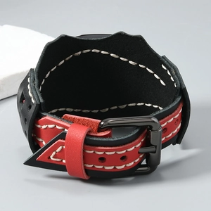 Macro shot of punk style leather wristband featuring black red layers and contrast stitching