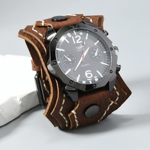 Detail of vintage brown leather strap with hand-stitched white seams and metal studs