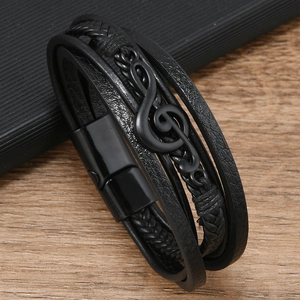 Detail eines mehrlagigen schwarzen Lederarmbands mit G-Clef-Musiknote und Magnetverschluss