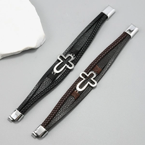 Detail of multi-layer leather bracelets with cross charm and magnetic metal clasp